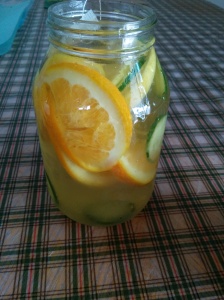 orange and cucumber water in jar