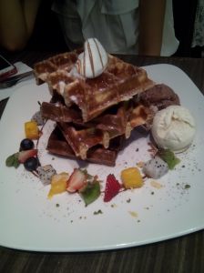 waffle topped with fruit and ice cream